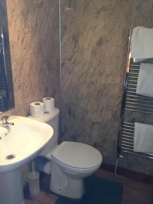 a bathroom with a white toilet and a sink at Glengorm Guest House in Oban