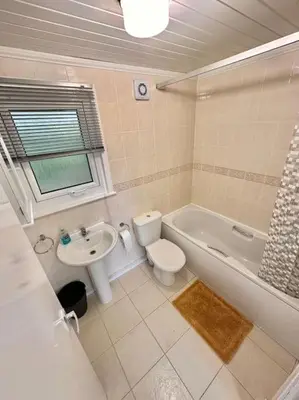 a bathroom with a sink and a toilet and a bath tub at Semi-detached 1-Bedroom Chalet at Maryville Caravan Site - Uddingston, Glasgow in Uddingston