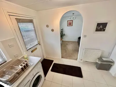a kitchen with a washing machine in a room at Semi-detached 1-Bedroom Chalet at Maryville Caravan Site - Uddingston, Glasgow in Uddingston