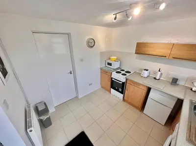 a kitchen with a stove and a counter top at Semi-detached 1-Bedroom Chalet at Maryville Caravan Site - Uddingston, Glasgow in Uddingston