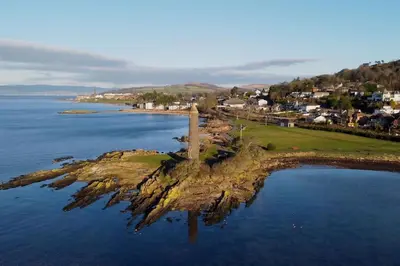 an island in the middle of the water at Stunning Coach House in Largs