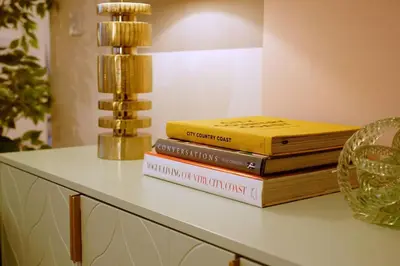 a stack of books sitting on top of a table at Stunning Coach House in Largs
