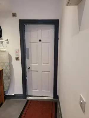 a white door with a black frame in a room at Luxe rooms in Edinburgh