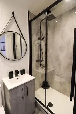 a bathroom with a sink and a shower at City Centre Hub Stirling, On Street Parking. in Stirling