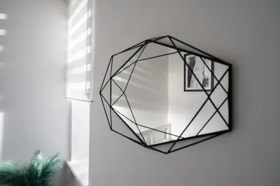 a mirror hanging on a wall in a room at Coatbridge Apartment in Coatbridge