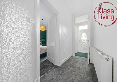 a hallway with a room with a bed and a door at Alexander Apartment by Klass Living Coatbridge in Coatbridge