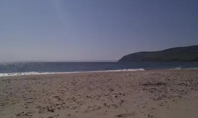 a sandy beach with the ocean in the background at Inishroel Cottage in Campbeltown