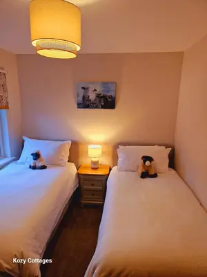 two beds sitting next to each other in a room at Ben Arthur Apartment in Lochgoilhead
