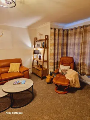 a living room with a couch and a table at Ben Arthur Apartment in Lochgoilhead