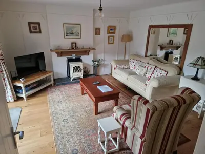 a living room with two couches and a tv at Langview in Arrochar