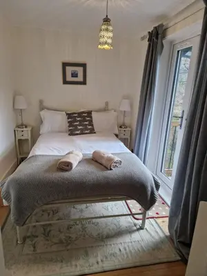 a bedroom with a bed with two towels on it at Langview in Arrochar
