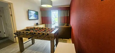 a room with a foosball table in front of a wall at Viewpoint Villa - Luxury 4 Bedroom villa with elevated views in Rothesay
