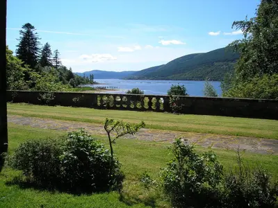 a view of a body of water next to a wall at Butlers Quarters Apartment in Cairndow