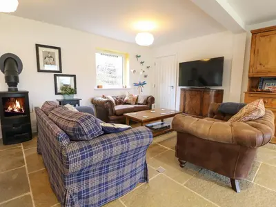 a living room with two couches and a fireplace at The Pier House in Lochgilphead
