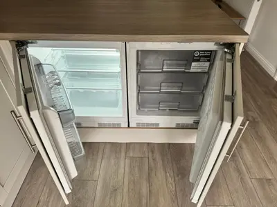 an empty refrigerator with its door open in a kitchen at Inchcailloch Townhouse, Loch Lomond in Bonhill