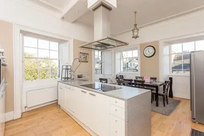 a kitchen with a counter top and a dining room at Prime Edinburgh City Centre - 4 Bed Penthouse in Edinburgh