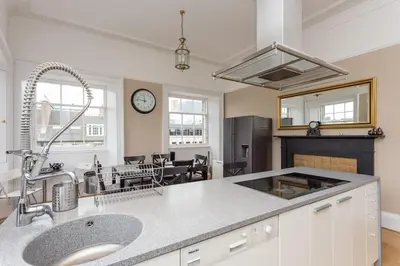 a kitchen with a sink and a counter top at Prime Edinburgh City Centre - 4 Bed Penthouse in Edinburgh