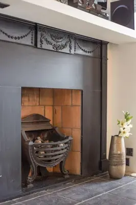 a dog sitting on a bench in a fireplace at Prime Edinburgh City Centre - 4 Bed Penthouse in Edinburgh