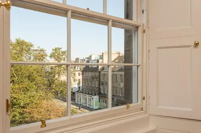 a window with a view of a city at Prime Edinburgh City Centre - 4 Bed Penthouse in Edinburgh