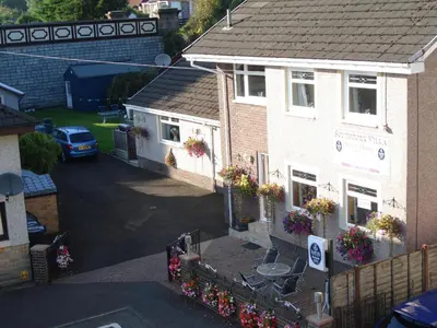 an overhead view of a house with flowers on the windows at Southfork Villa Guesthouse in Callander