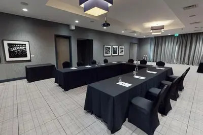 a conference room with a long table and chairs at Village Hotel Edinburgh in Edinburgh