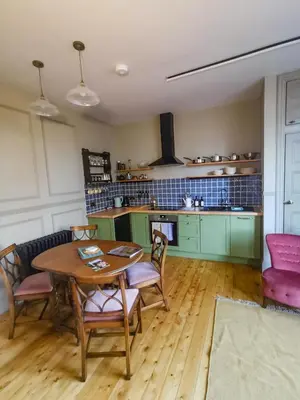 a kitchen with a table and chairs in a room at Jameswood Villa in Sandbank