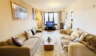 a living room with two couches and a tv at Beautiful & Spacious 2-Bed Flat in City Centre with Free Parking in Glasgow