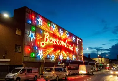 a building with a neon sign on the side of it at Spacious Modern Apartment in Glasgow
