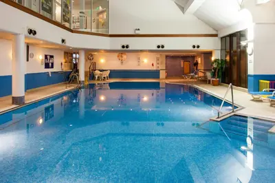 a large swimming pool in a hotel room at Holiday Inn Glasgow - East Kilbride by IHG in East Kilbride
