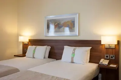 a hotel room with two beds and a phone at Holiday Inn Glasgow - East Kilbride by IHG in East Kilbride