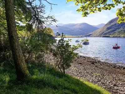 a view of a lake with boats in the water at Roe Deer Cottage in North Ballachulish