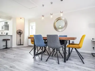 a dining room table with chairs and a mirror at The White House in Callander