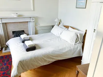 a bedroom with a bed with two towels on it at Spacious 2-Bedroom Georgian Edinburgh City Apartment in Edinburgh