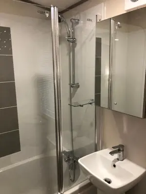a bathroom with a shower and a sink at Lovely Caravan in Turnberry