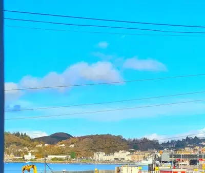a view of a city and a body of water at The Rail & Ferry Den in Oban