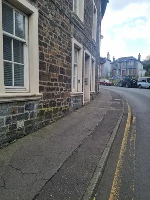 an empty street next to a brick building at The Rail & Ferry Den in Oban