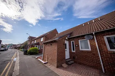 a brick house on the side of a street at The Bradan - Troon - Coorie Doon Stays in Troon