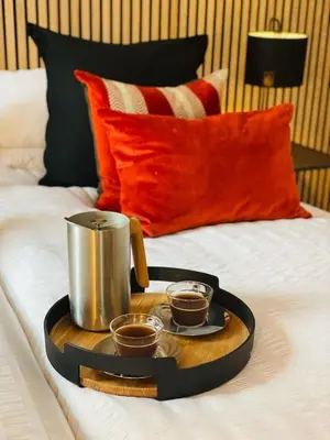 a tray with two cups of coffee on a bed at 2 bed lodge with private hot tub in Aviemore in Saint Ninians