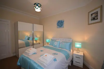 a bedroom with a bed with towels on it at Wallace Apartment in Stirling