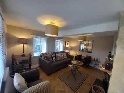 a living room with a couch and a table at Beautiful Historic Cottage in Callander
