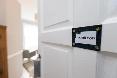 a door with a sign on the side of it at Kilmaronock Manse B&B in Drymen