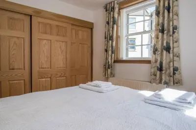 a bedroom with a bed with two towels on it at Luxury Flat, 20 Minutes by train from Edinburgh in Inverkeithing