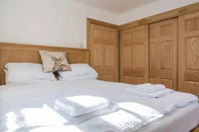 a bedroom with a bed with towels on it at Luxury Flat, 20 Minutes by train from Edinburgh in Inverkeithing