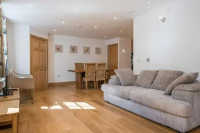 a living room with a couch and a table at Luxury Flat, 20 Minutes by train from Edinburgh in Inverkeithing