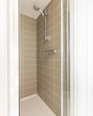 a shower with a shower head in a bathroom at Luxury Detached Home in Edinburgh