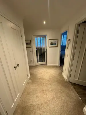 an empty room with a hallway with a door at Luxury Moffat Apartment - High End Furnishing in Moffat