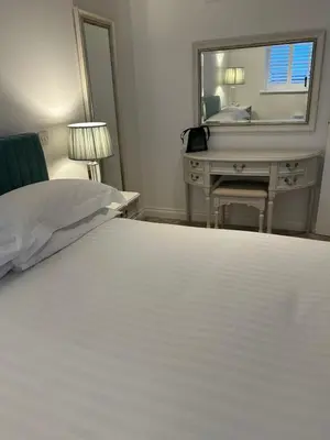 a bedroom with a bed and a desk and a mirror at Luxury Moffat Apartment - High End Furnishing in Moffat