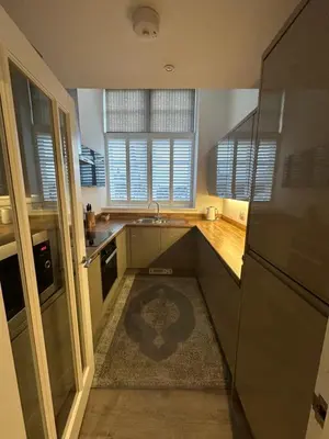 a kitchen with a sink and a refrigerator at Luxury Moffat Apartment - High End Furnishing in Moffat