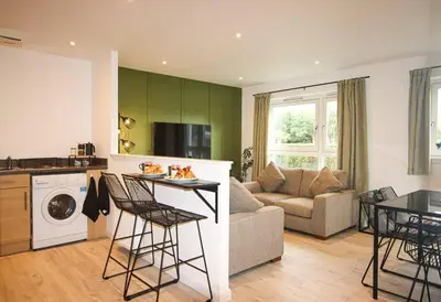 a kitchen and living room with a couch and a table at City Hub by the Castle Free Designated Parking in Stirling