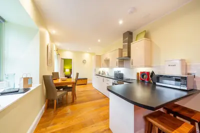 a kitchen with a counter and a dining room at Lochelour Mill Cottage in Perth
